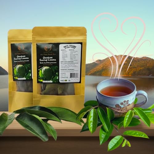 Two pouches of Inspired Gems Jamaican Soursop Leaves next to a steaming cup of tea and fresh green leaves, set against a peaceful lakeside mountain landscape